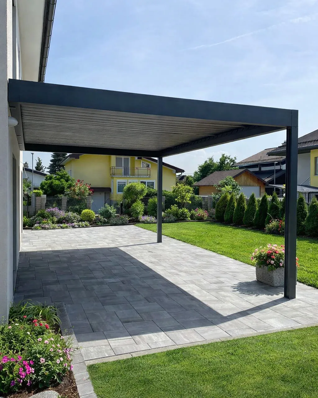 Wall-mounted aluminium pergola in a compact terraced garden in Dublin